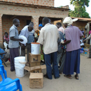 community members buy spouts of water filters