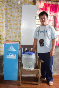 Von Auristela with his family's water filter.