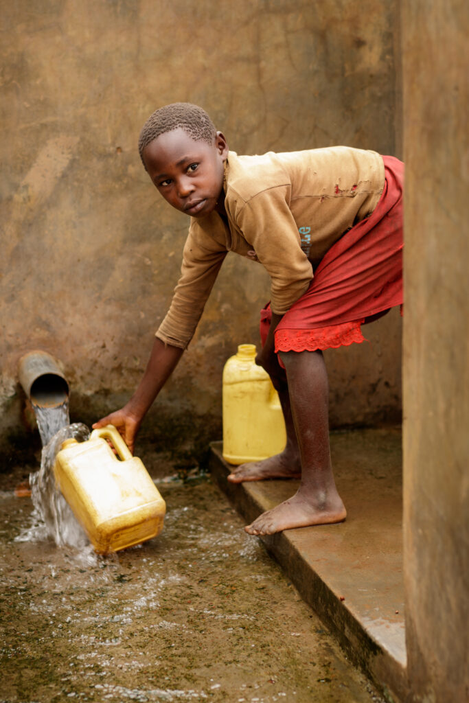 A child collecting water from a rehabilitated well. Photo credit: Bob and Dawn Davis