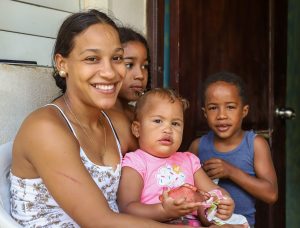 Woman smiling with three kids