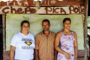 A woman, a man and a younger woman, together a family, standing and smiling